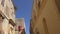 Driving narrow street with old buildings