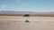 Driving plate side view moving through desert in car