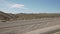 Driving plate side view moving through desert in car empty road