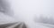 Driving POV personal perspective of covered with snow mountain highway