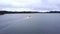 Driving with pvc boat on in aland islands. Drone video in windy day. Pvc motorboat with fisherman on board.