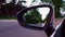 Driving Residential Road View of Side Mirror.  Driver Point of View POV of Side View Mirror Along Beautiful Street.