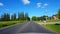 Driving Rural Road Along Residential Homes During Bright Summer Day.  Driver Point of View POV Beautiful Suburb Houses