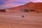 Driving through the Sahara Desert in Morocco at sunset