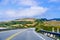 Driving on the scenic Highway 1 (Cabrillo Highway) on the Pacific Ocean coastline close to Davenport, Santa Cruz mountains visible