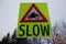 Driving slow sign in road traffic