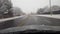 Driving through snowy suburb in daytime