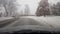 Driving through snowy suburb in daytime