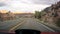 Driving in the southwestern United States: empty road and stormy sky over natural bridges park, Utah.