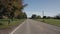 Driving straight on a flat road in a typical American agricultural region. Driver's view