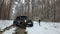 Driving SUV 6x6 by the off-road in the winter forest. Off-road. Jeeping