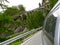 Driving in swiss mountains - side of car and an arch bridge