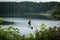 Driving in Vancouver Island, British Columbia: a lake with a tree growing on a rock