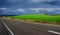 Driving, Vibrant Green, Stormy Sky