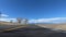 Driving west towards the Rocky Mountains of Colorado during a clear winter day.