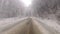 Driving in the winter fog covered mountain asphalt road