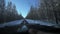 Driving through the winter forest on snowy road