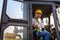 Driving worker heavy wheeled tractor, Wheel loader Excavator with backhoe unloading sand works in construction site