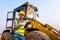 Driving worker heavy wheeled tractor, Workers drive orders through the iPad, Wheel loader Excavator with backhoe unloading sand