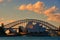 A drmatic scene of reddish and yellowish burning clouds over Sydney house opera and harbour bridge