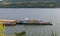 Drobeta Turnu Severin, Romania. August, 13, 2019- A ship pushes barges to shore on the Danube. The picture taken on the shore