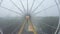 Drone 4k video ferris wheel in a city amusement park on a foggy morning