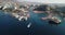 Drone above marina port boats at the sea water or ocean at a desert tropical landscape with hotels and tourist
