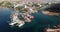 Drone above marina port boats at the sea water or ocean at a desert tropical landscape with hotels and tourist