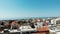 Drone aerial 360 shot of cyprus city paphos with mountains and sea in background. Business centers and rooftops of buildings with