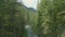 Drone aerial flying over a wild mountain river in Dolomites Alps