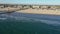Drone Aerial Hovering High Above Pacific Ocean at Huntington Beach California Facing the Beach