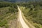 Drone Aerial Of Long Dirt Road Through Bush