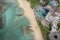 Drone aerial of luxury holiday hotel resort and sandy tropical beach in winter