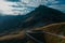 Drone aerial panorama on the Jaufenpass or Passo Giovo in northern italy with beautiful road winding on the mountain and sun just