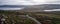 Drone aerial panoramic view of a camper van in green and red landscape with atlantic ocean in Tourinan Cape in Galicia, Spain