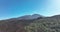 Drone aerial of the peak of a volcanic mountain in a national nature park, rocky rough beautiful landscape on a island