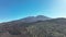 Drone aerial of the peak of a volcanic mountain in a national nature park, rocky rough beautiful landscape on a island