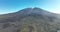 Drone aerial of the peak of a volcanic mountain in a national nature park, rocky rough beautiful landscape on a island