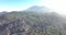 Drone aerial of the peak of a volcanic mountain in a national nature park, rocky rough beautiful landscape on a island