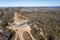 Drone aerial photograph of flood water on a dirt road in a forest