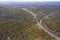 Drone aerial photograph of a highway running through a forest in regional Australia