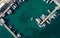 Drone aerial scenery of a fishing port. Fishing boats and yachts moored in the harbour