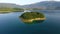Drone aerial shoot of small island on Ramsko Jezero lake - a tourist destination near Prozor, Bosnia and Herzegovina