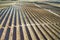 Drone aerial shooting of solar power farm raws of reflective panels. At cloudy day