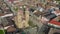 Drone aerial shot of a brick church with two towers in the center of the village