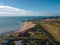 Drone aerial shot of Empty Kingsgate Beach and Castle on the cliffs above the Bay, on cloudy autumn morning