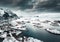 Drone aerial shots, photos in Henningsvaer, Lofoten Norway during cloudy weather winter time with snowy epic mountains