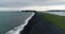 Drone aerial video of Iceland famous black sand beach Reynisfjara with people