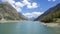 Drone aerial view of the Lake Livigno with with pedal boats. Italian Alps. Italy