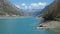 Drone aerial view of the Lake Livigno with with pedal boats. Italian Alps. Italy